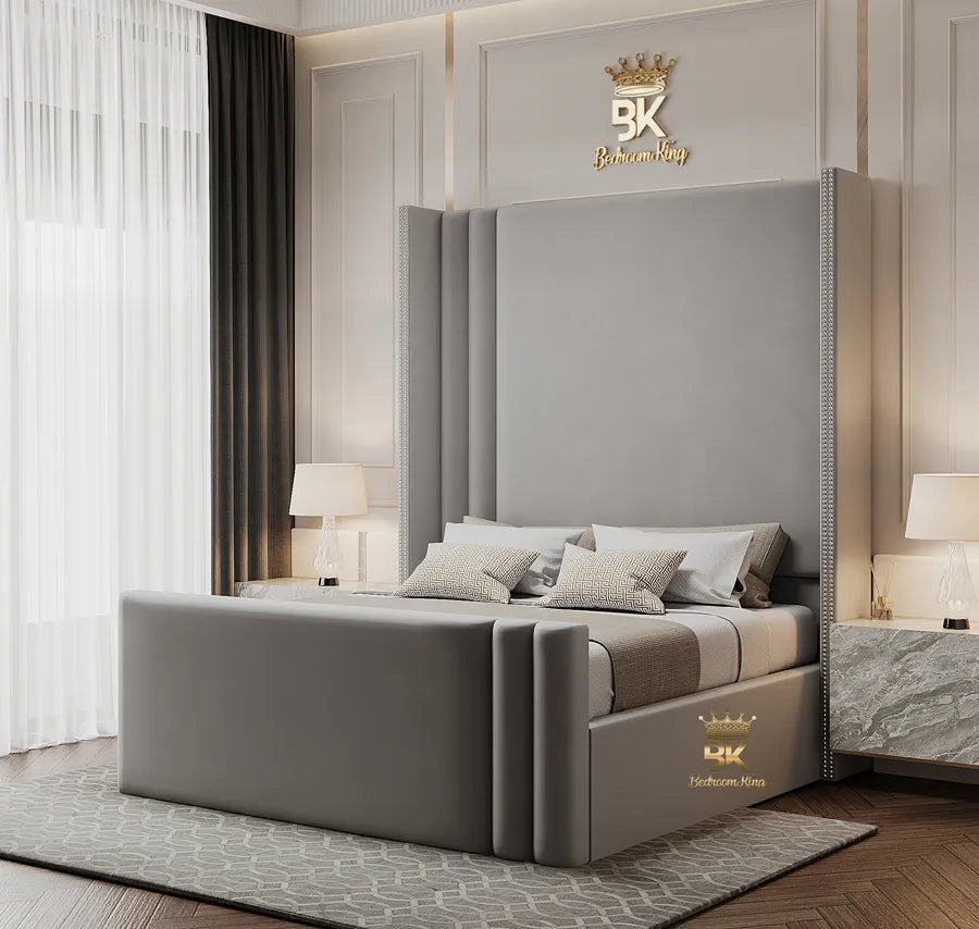 A gray wingback bedframe with storage