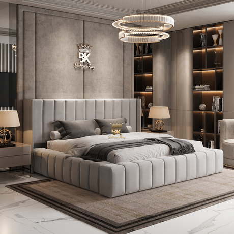 Modern bedroom with a gray upholstered bed, nightstands, and decorative elements.