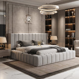 Modern bedroom with a gray upholstered bed, nightstands, and decorative elements.