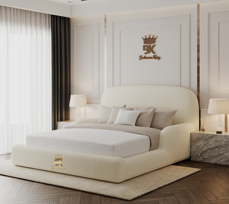 Luxury bedroom with a large teddy fabric bed and decorative wall panel featuring a logo.