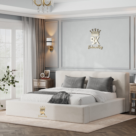 Modern bedroom with a cream padded king size bed, nightstands, and decorative wall art.