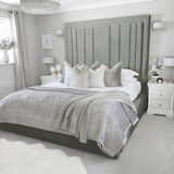 Neatly made bed frame with silver plush velvet 